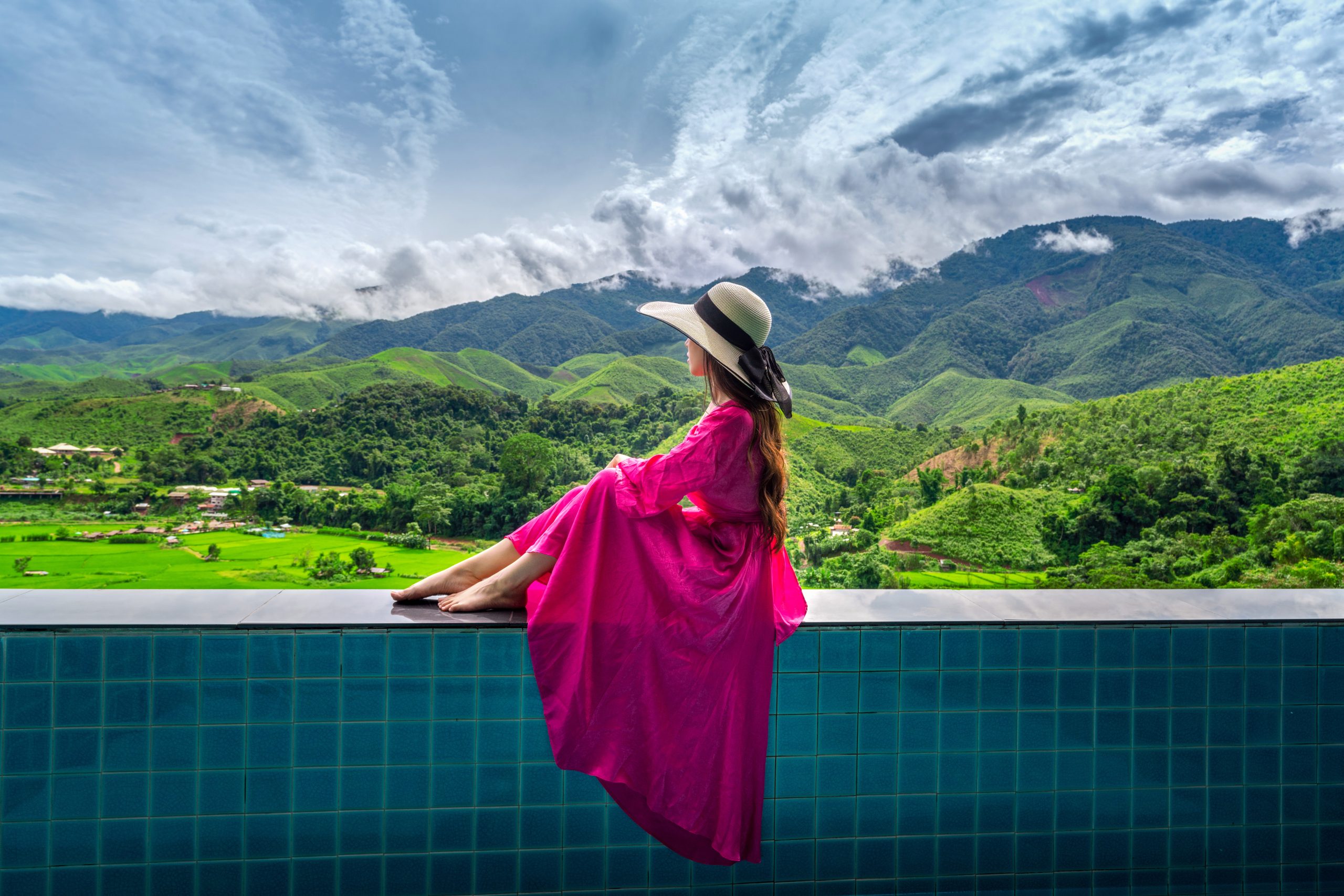 Woman enjoying rice terrace viewpoint and green forest in Nan, T
